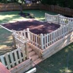 Timber retaining wall and picket fence Dallas GA Lawn Frogs Landscaping