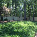 Wood privacy fence in natural backyard Cobb County GA Lawn Frogs Landscaping